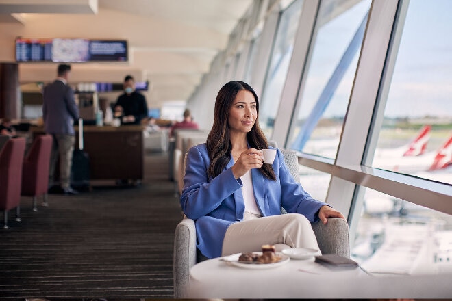 Qantas Club lady drinking coffee