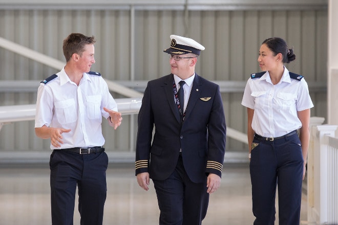 Male pilot with male and female students