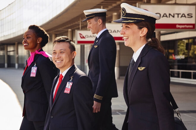 Qantas pilot and crew walking out of Qantas terminal