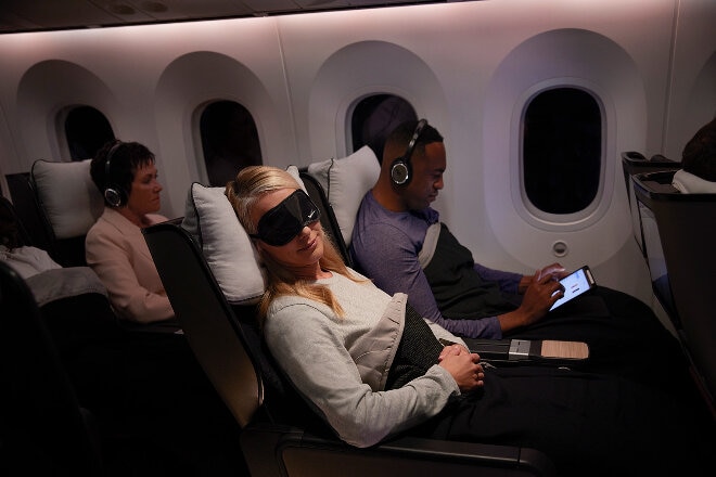 Female sleeping in 787 Premium Economy