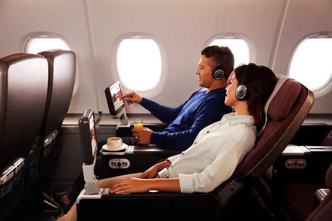 Couple relaxing in Premium Economy