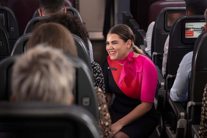 Female flight attendant assistant passenger on Qantas flight