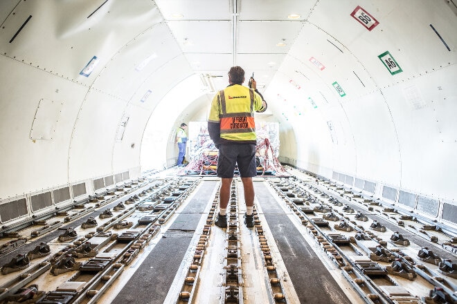 Qantas Freight employee inside a cargo plane