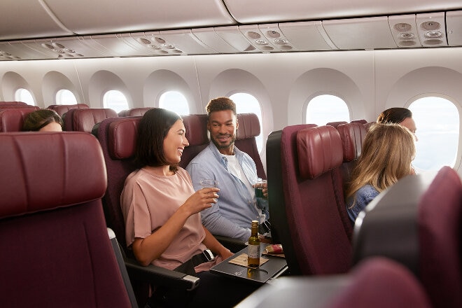 Mum and child sitting in Economy receiving their inflight meals