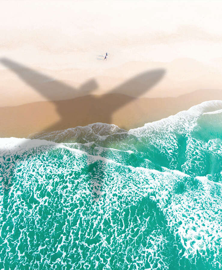 Aircraft shadow over beach