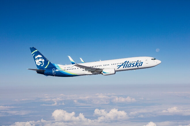 Alaska Airlines aircraft flying above the clouds