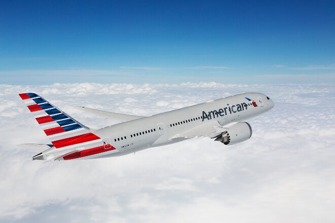 American Airlines aircraft flying above clouds