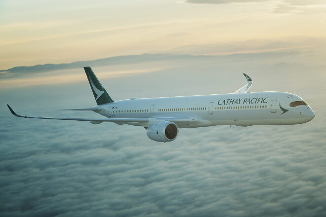 Cathay Pacific aircraft flying above clouds