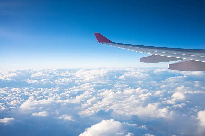 Air Tahiti Nui aircraft wing in flight above the clouds