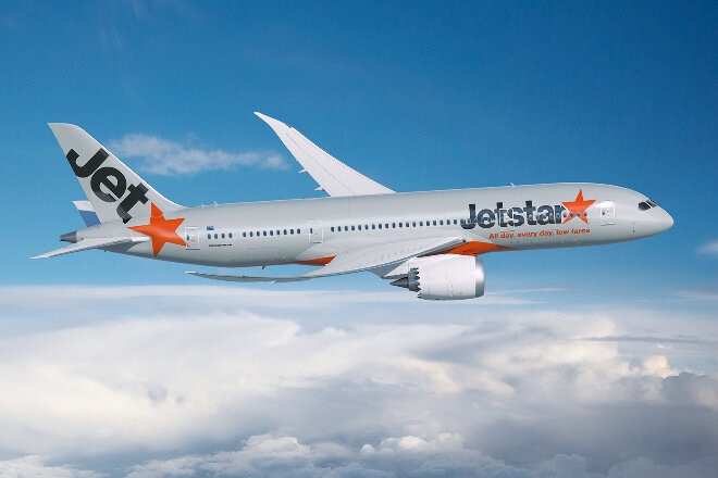 Jetstar aircraft flying above the clouds