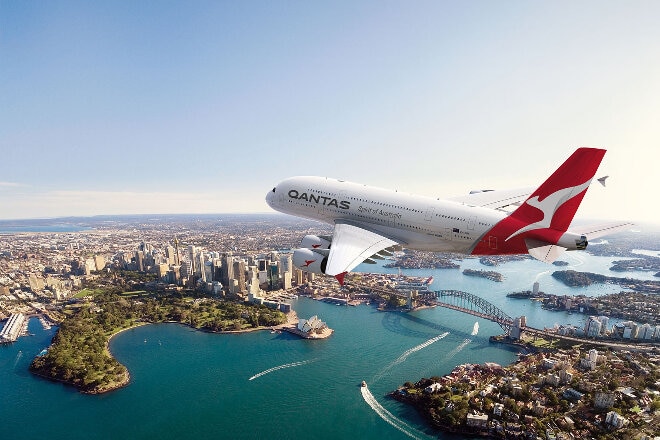 Qantas aircraft flying over Sydney harbour