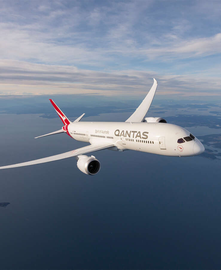 Qantas aircraft flying over the ocean