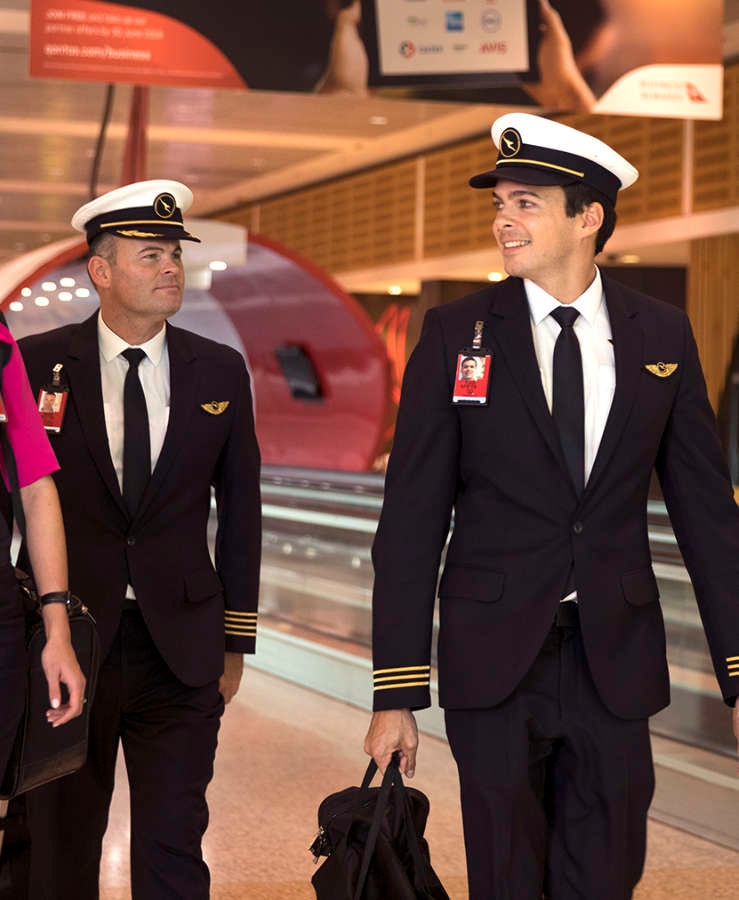 Qantas crew walking through Sydney terminal