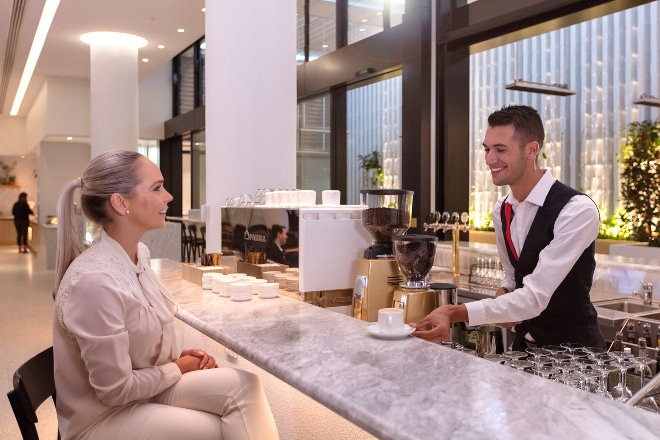 Perth transit lounge - Barista serving women