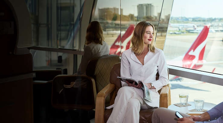 Lady looking out the window in the Qantas Club