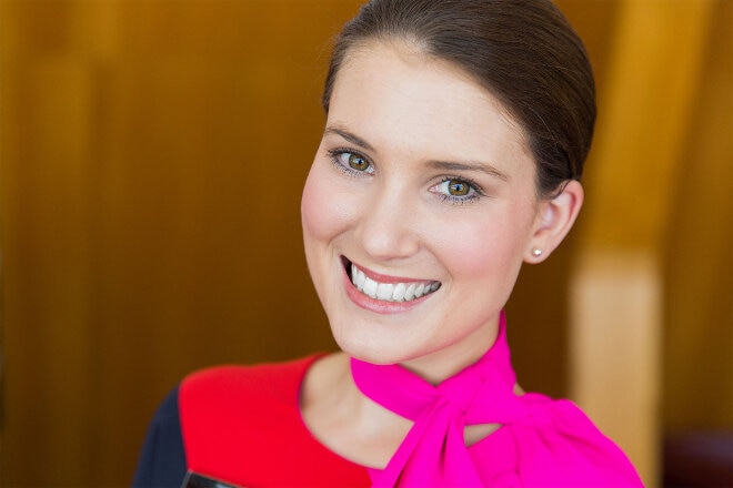 A Qantas staff assisting a passenger with checking in