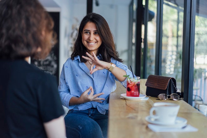 Two ladies using sign language to communicate