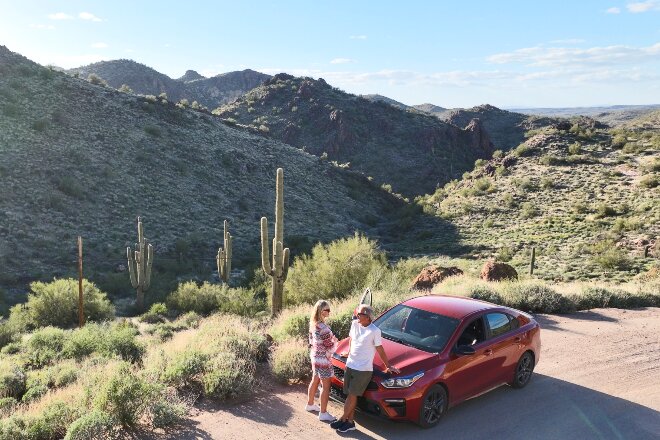 Couple on roadside enjoying desert view