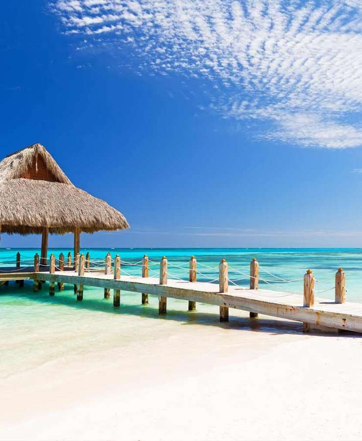 Beach hut and pier over crystal clear ocean