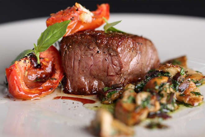 Beef steak and tomatoes on plate