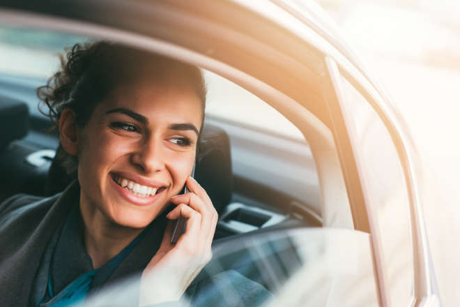 women in car smiling