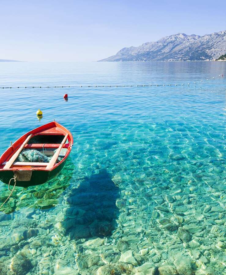 wooden boat in clear water