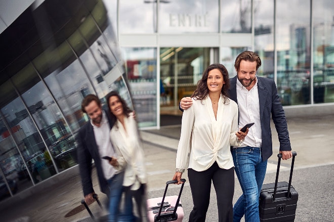 Couple leaving airport with luggage