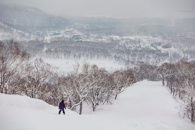 snowboarder riding down mountain