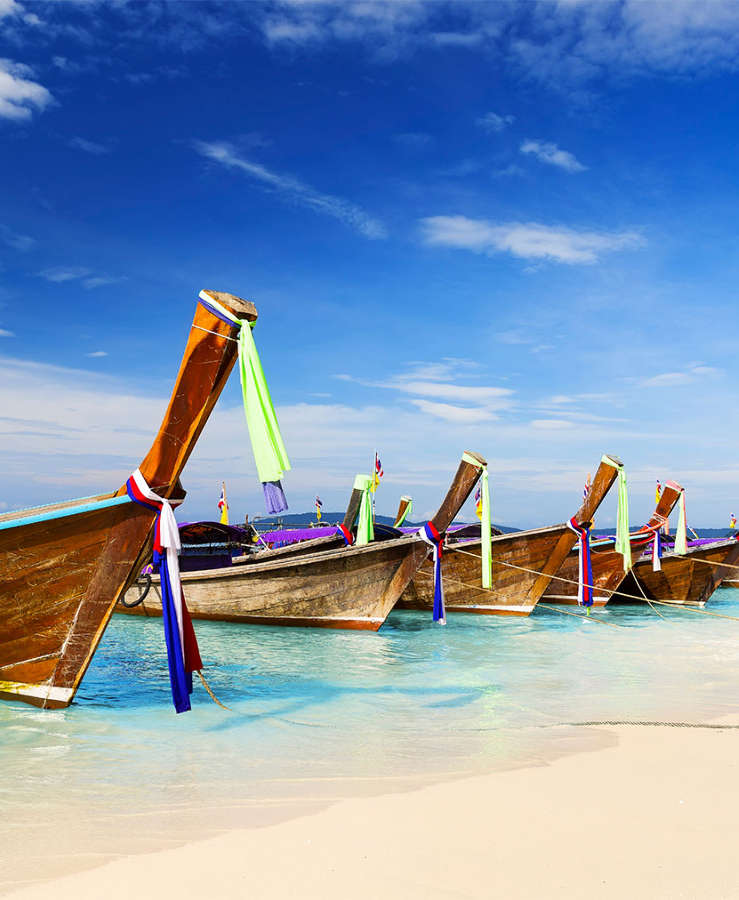 long boat floating on beach shoreline