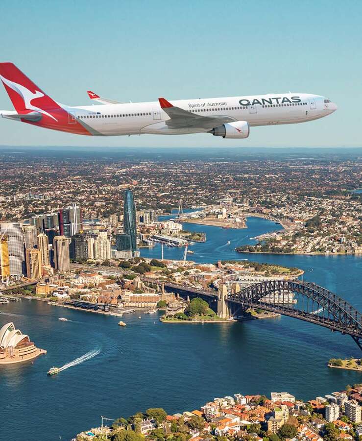 Qantas A330 flying across Sydney Harbour