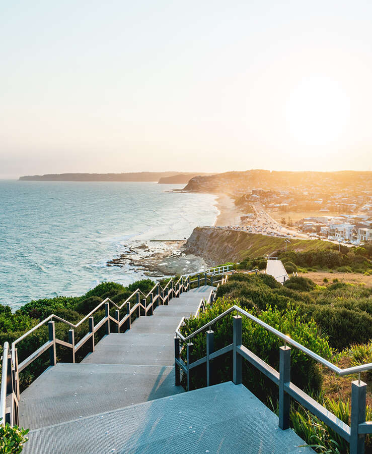 Anzac Memorial Walk and Bar Beach at sunset in Newcastle