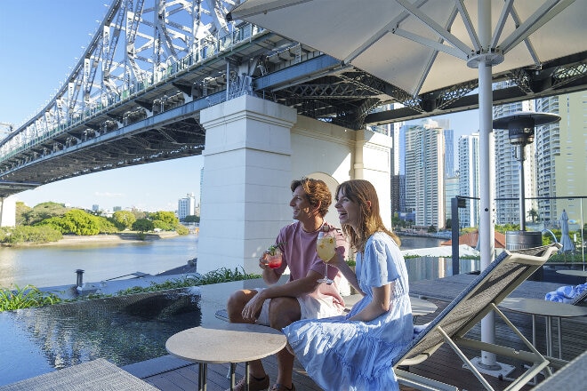 Couple having a drink on Brisbane riverfront