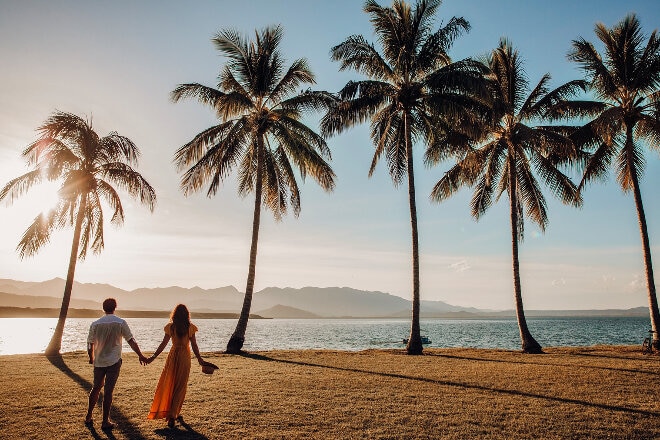 Couple walking on beach in Cairns