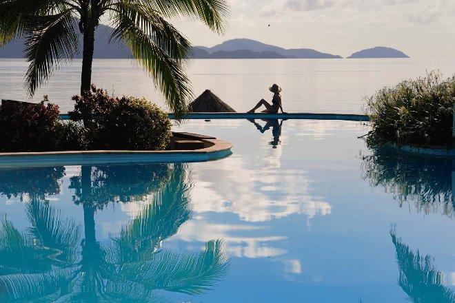 Lady relaxing at hamilton island pool