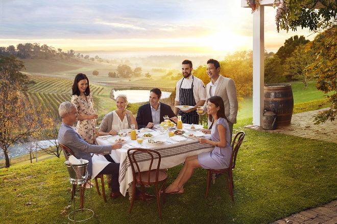 Family eating dinner at vineyard 