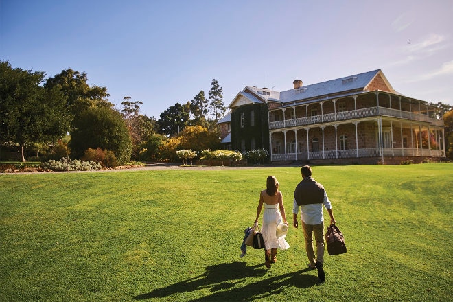 Couple holding hands at sunning homestead