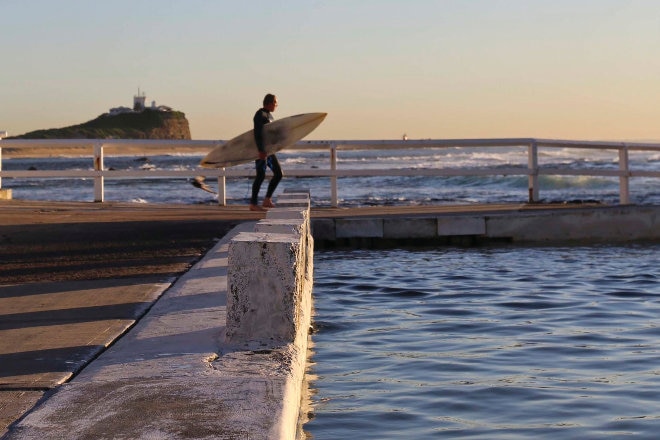 Surfer diving into ocean