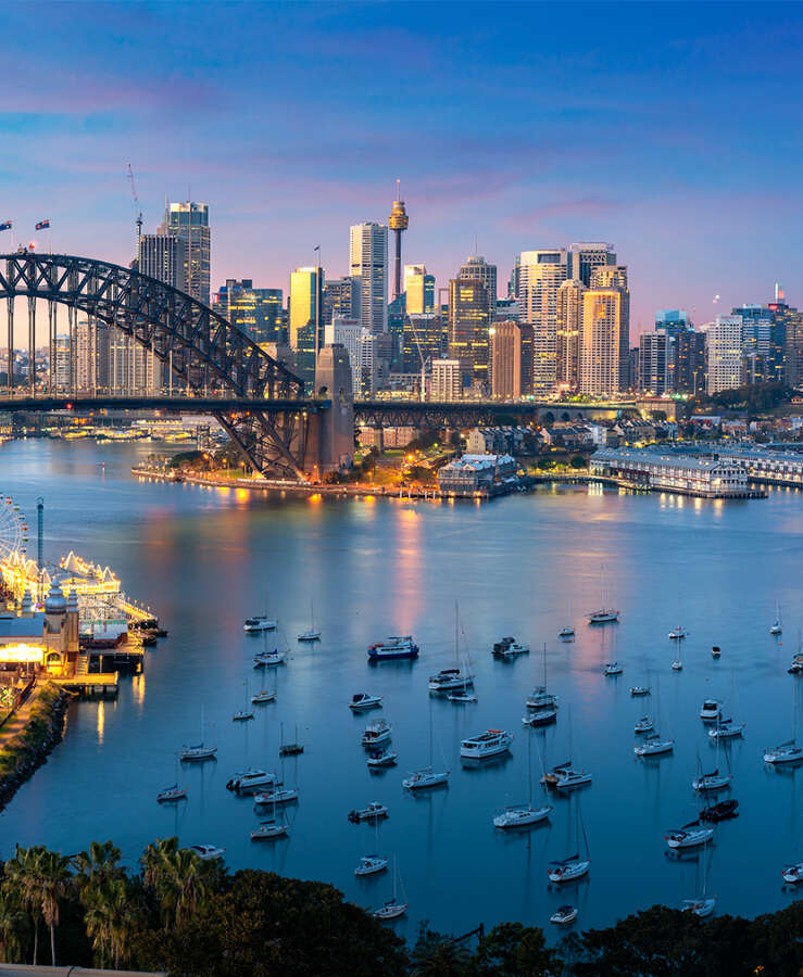 Cityscape image of Sydney, Australia with Harbor Bridge and Sydney skyline during sunset. Vacation and travel in Australia.