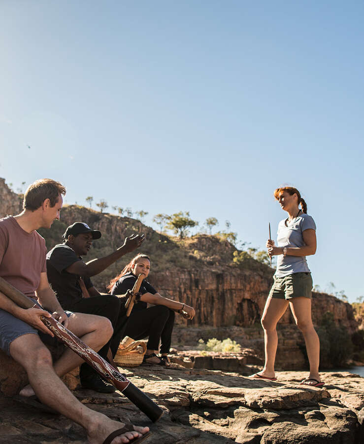 Tourists learning about Aboriginal culture