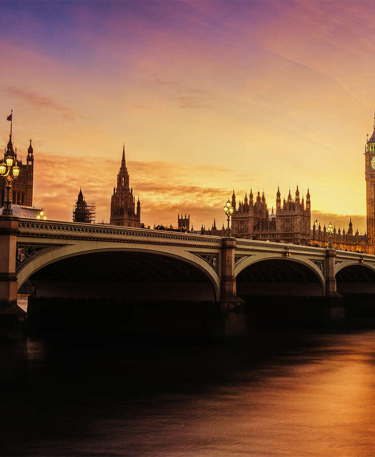 Sunset beams over the Big Ben clock tower in London, UK.