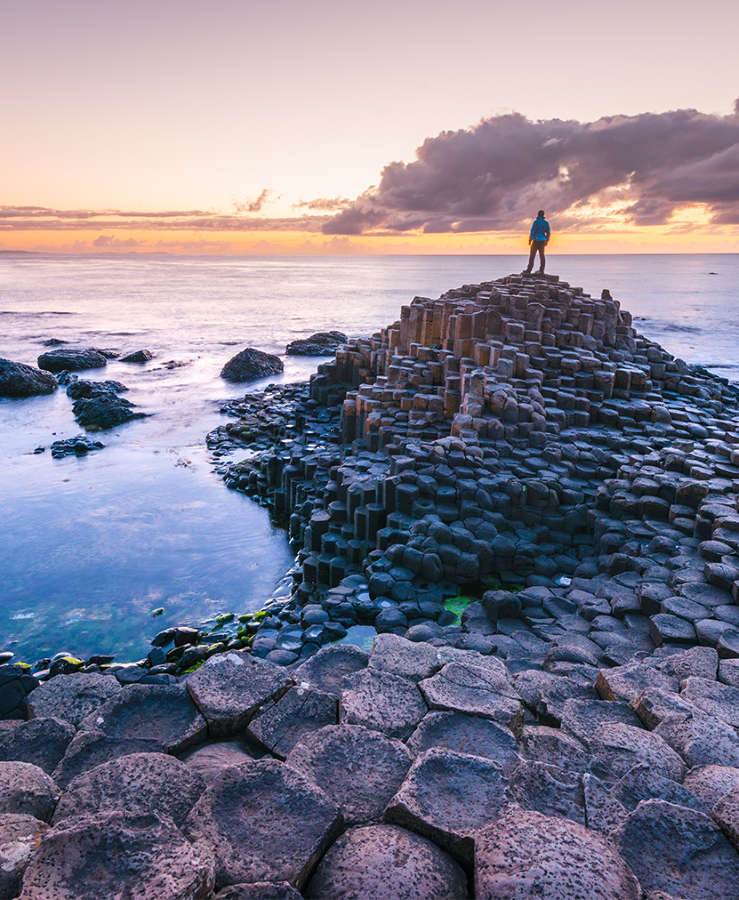 Man standing on rocks in Ireland