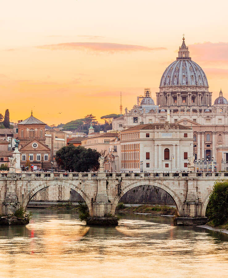 Rome skyline at sunset with Tiber river and St. Peter's Basilica, Italy