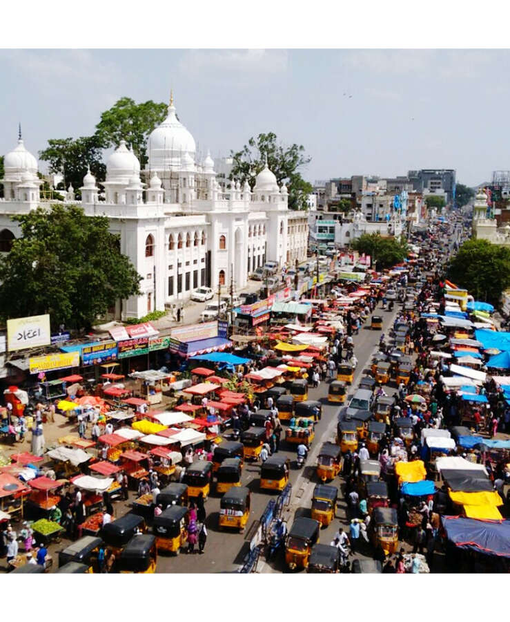  High Angle View Of Vehicles Amidst Buildings On Sunny Day In City