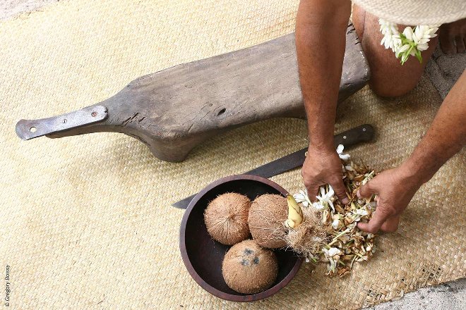 Local cutting a coconut in Noumea