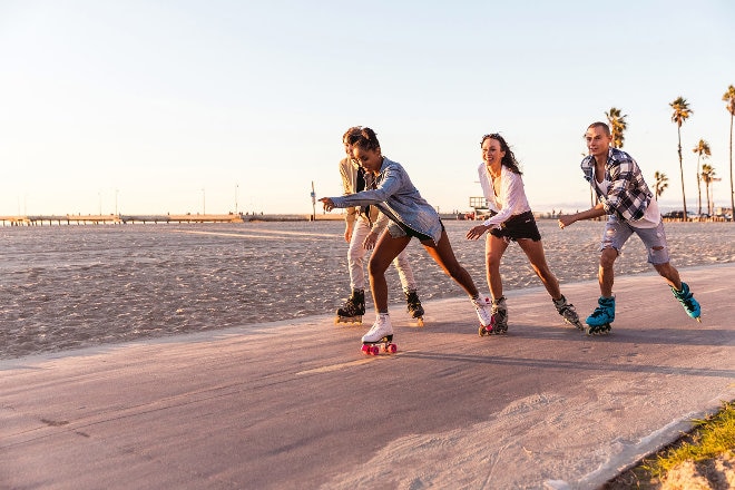 People rollerblading on beach boardwalk