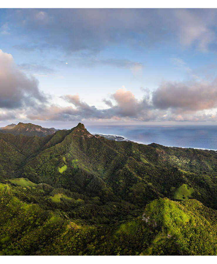 Dramatic sunset over the jungle coverded mountain in Rarotonga island in the Cook islands.