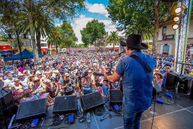 Lee Kernaghan playing guitar to crowd