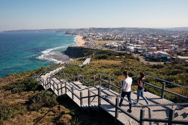 Couple walking along Newcastle Memorial Walk