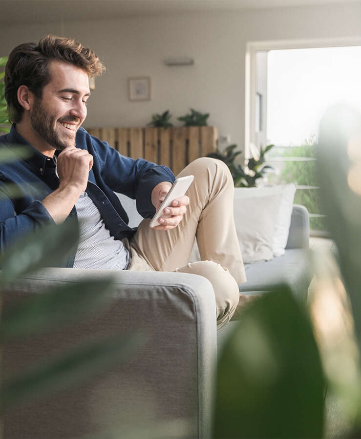 Man on lounge looking at mobile