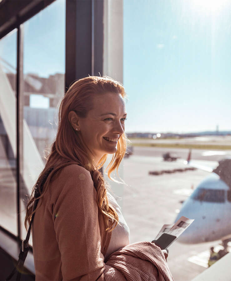 lady at airport overlooking runway